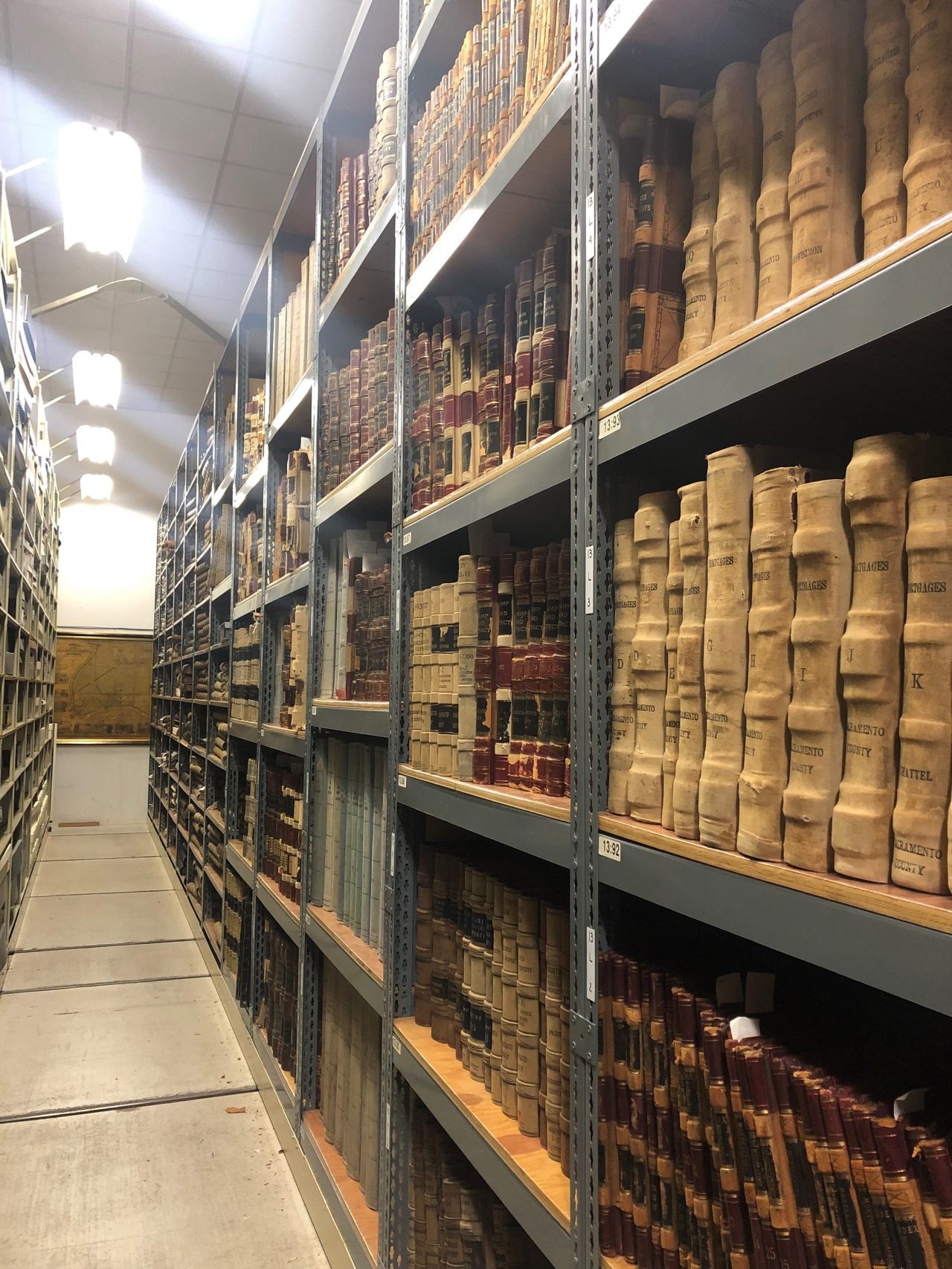 An aisle at CSH with volumes on shelves