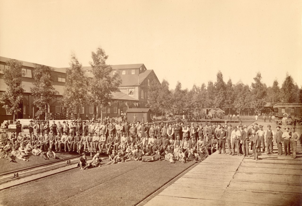 A large group of men pose in the Central Pacific rail yards