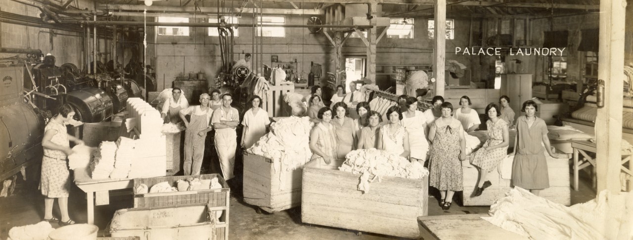 A group of people pose inside a laundry