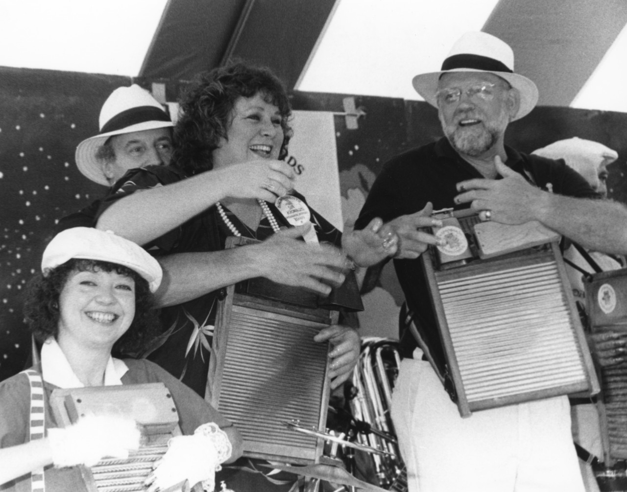 A group of performers with three playing the washboard.